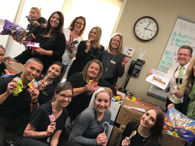 Dental team holding candy during an office collection, from Troopathon
